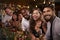 Friends enjoying Christmas celebrations look to camera