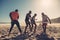 Friends enjoying a game of soccer at beach