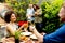 Friends grilling food and enjoying barbecue party outdoors