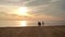 Friends group rest on beach. POV walking on beach