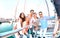 Friends group taking selfie pic with stick on luxury sailing boat party trip - Friendship concept with young millenial people