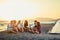 Friends with guitar at beach enjoyment. friends relaxing on sand