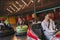 Friends having fun on bumper cars in amusement park