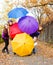 Friends hiding behind umbrellas