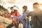 Friends hikers group trekking on french alps mountain at sunset