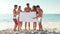 Friends holding blank poster at the beach