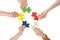 Friends holding colorful jigsaw pieces