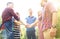 Friends join hand together during at barbecue in nature.