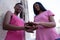 Friends joining hands for breast cancer awareness