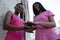 Friends joining hands for breast cancer awareness