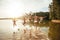 Friends jumping into the water from a jetty