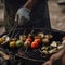 Friends making barbecue and having lunch in the nature. Man fries kebab on the grill.