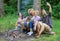 Friends near bonfire enjoy vacation and roasted food. Man taking photo near bonfire nature background. Tourists sit log