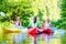 Friends paddling with canoe on river