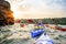 Friends Paddling Kayaks on the Beautiful River or Lake near High Rock under the Dramatic Evening Sky at Sunset.