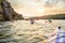 Friends Paddling Kayaks on the Beautiful River or Lake near High Rock under the Dramatic Evening Sky at Sunset.