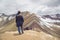 Friends with panoramic views. Hiking scene in Vinicunca, Cusco region, Peru. Montana of Seven Colors, Rainbow Mountain