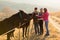 Friends petting horses