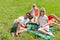 Friends picnic people group sitting blanket outdoor green grass