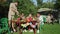 Friends picnic together in the park and enjoy watermelon and drink