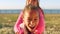 Friends, piggyback and girls playing in nature by the coast while on holiday and having fun. Little children, female