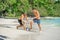 Friends playing footbal at the sunny tropical beach