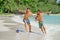 Friends playing footbal at the sunny tropical beach