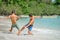 Friends playing footbal at the sunny tropical beach