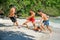 Friends playing footbal at the sunny tropical beach