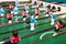 Friends Playing Table Soccer Game. table football or kicker with miniature players. game table. Games, entertainment