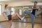 Friends practicing dance against mirror on floor