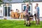 Friends preparing barbecue in back yard