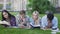 Friends preparing for exams, reading materials in university garden, education