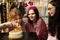 Friends presenting birthday cake to girl. Happy birthday to you