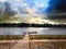 Friends refreshing their feet on Rhine river at a wooden pier in Bonn, Germany