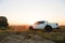 Friends Riding Bikes in the Mountains in front of the Pickup Off Road Truck at Sunset. Adventure and Travel Concept