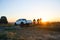 Friends Riding Bikes in the Mountains in front of the Pickup Off Road Truck at Sunset. Adventure and Travel Concept