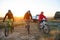 Friends Riding Bikes in the Mountains in front of the Pickup Off Road Truck at Sunset. Adventure and Travel Concept