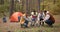 Friends roasting marsh mellows on sticks at bonfire and having fun at camp fire