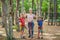 Friends on the ropes course. Young people in safety equipment are obstacles on the road rope Portrait of a disgruntled