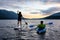 Friends on Scenic Lake Kayaking and Paddleboarding Together