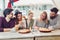 Friends sharing pizza in a indoor cafe