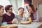 Friends sharing pizza in a indoor cafe