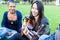 Friends singing songs in park having fun together