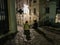 Friends sit on the top cobbled step of a Montmartre sidewalk, Paris, France, on a summer evening