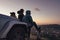 Friends sitting on a hilltop looking at the city below