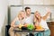 Friends sitting at table in kitchen