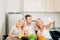 Friends sitting at table in kitchen