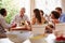 Friends sitting at a table talking during a dinner party