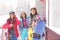 Friends with skis and snowboards wearing winter sport clothes outdoors